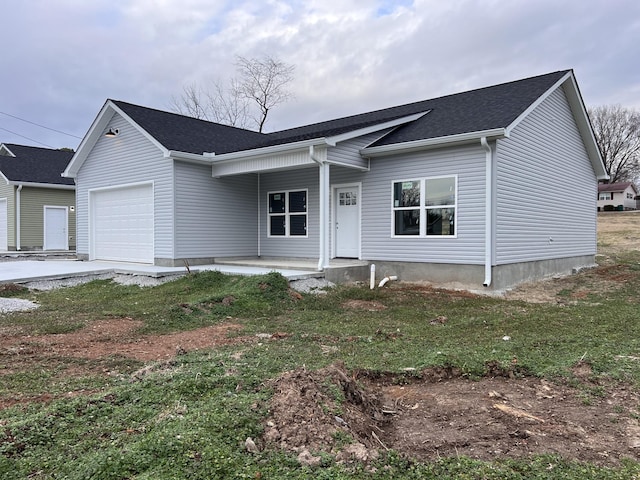 ranch-style house with a garage, covered porch, and a front yard