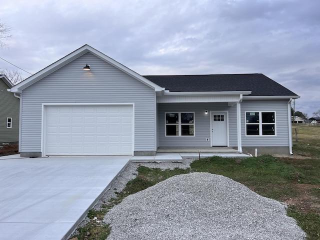 single story home with a garage and covered porch