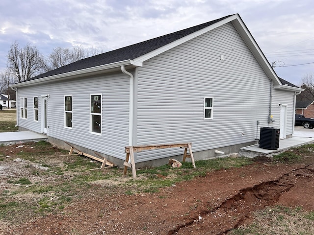 view of side of home with central AC