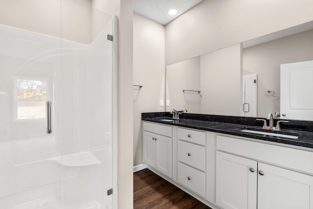 805 Shepard St S, Winchester, TN 37398 - bathroom featuring a stall shower, double vanity, wood finished floors, and a sink