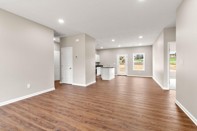805 Shepard St S, Winchester, TN 37398 - unfurnished living room with visible vents, dark wood-style floors, baseboards, and recessed lighting