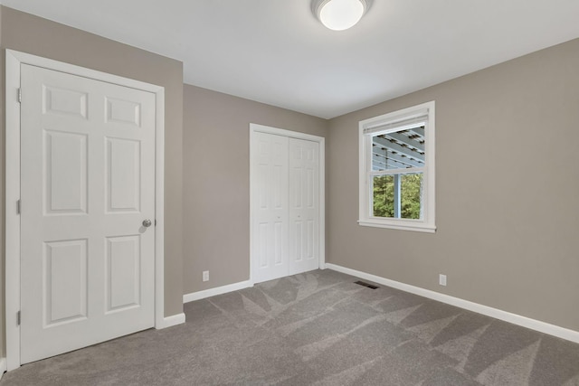 unfurnished bedroom featuring a closet and carpet