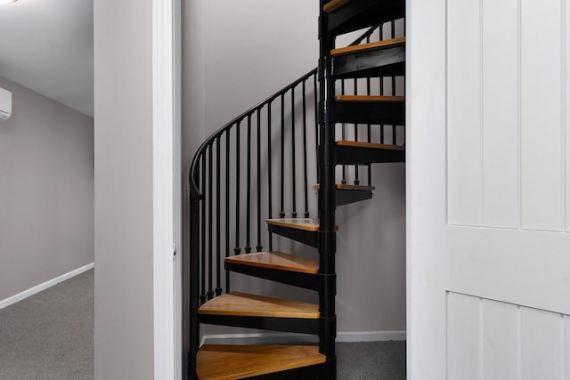 staircase featuring an AC wall unit and carpet