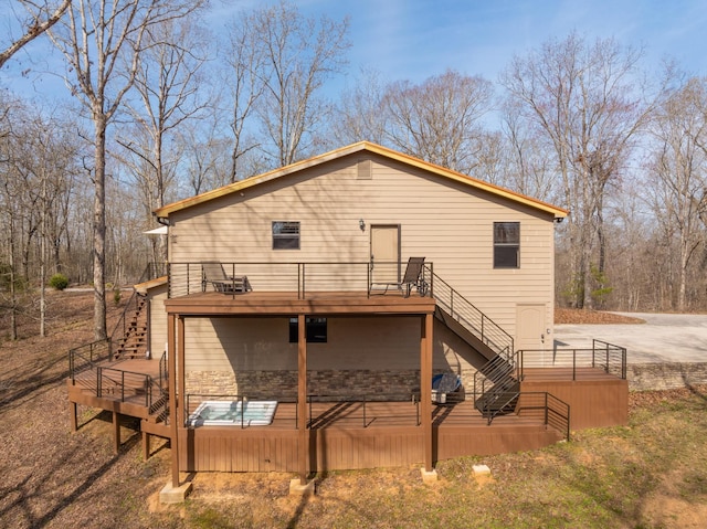 rear view of house featuring a wooden deck