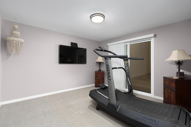 exercise area featuring light colored carpet