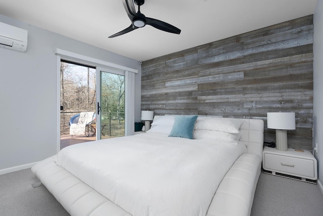 bedroom with a wall mounted air conditioner, access to outside, wooden walls, carpet floors, and ceiling fan