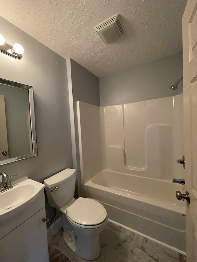 full bathroom with shower / bathing tub combination, vanity, toilet, and a textured ceiling