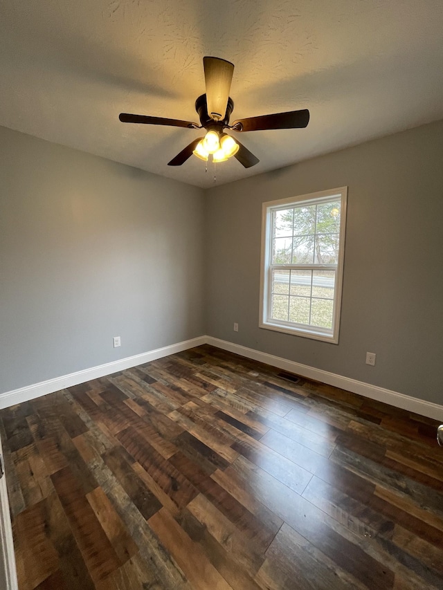 spare room featuring ceiling fan and dark hardwood / wood-style flooring