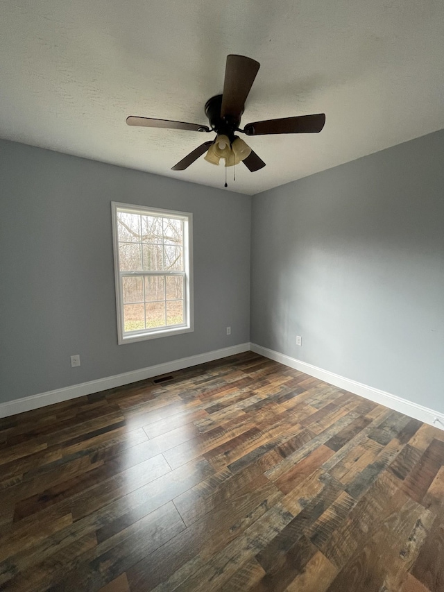 empty room featuring dark hardwood / wood-style floors and ceiling fan