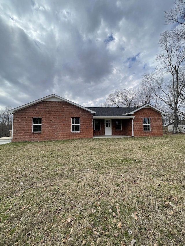 rear view of property featuring a yard