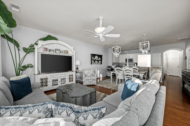 living room featuring dark hardwood / wood-style floors and ceiling fan