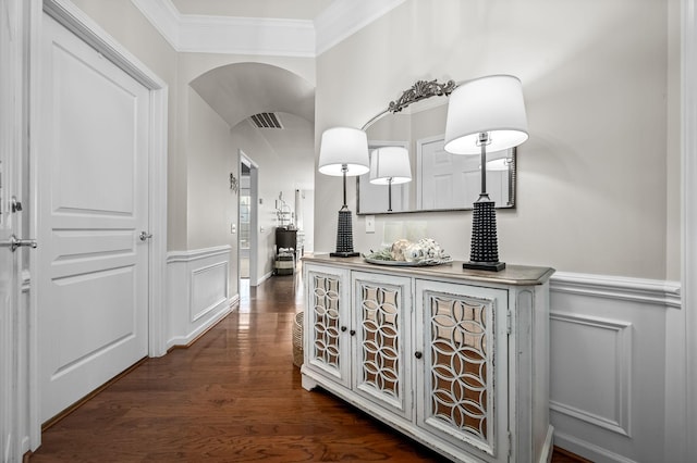 corridor with ornamental molding and dark hardwood / wood-style flooring