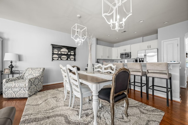 dining area featuring an inviting chandelier and dark hardwood / wood-style floors