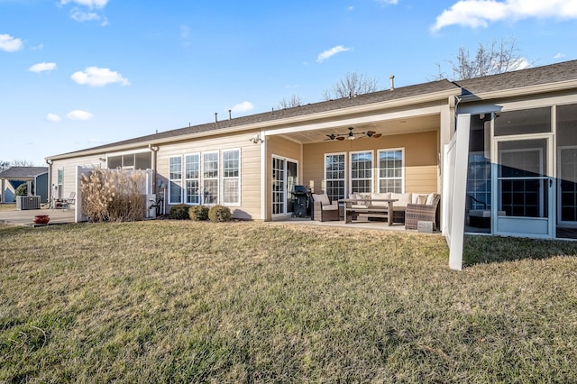 back of house featuring a patio area, an outdoor hangout area, a sunroom, and a lawn