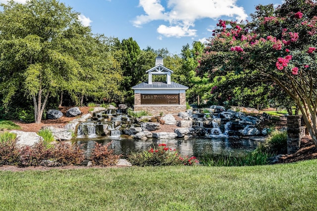 community sign featuring a lawn