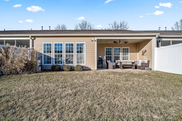 back of property featuring an outdoor living space, a lawn, ceiling fan, and a patio area