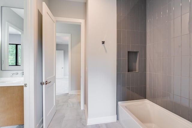 bathroom with vanity and tiled shower / bath