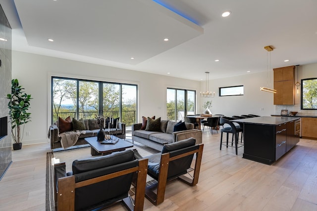 living room featuring light hardwood / wood-style floors and a notable chandelier