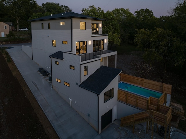 exterior space featuring a garage and a balcony