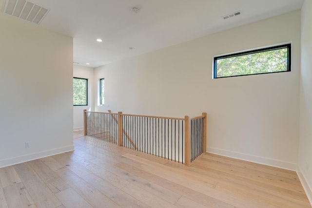 empty room with light hardwood / wood-style flooring