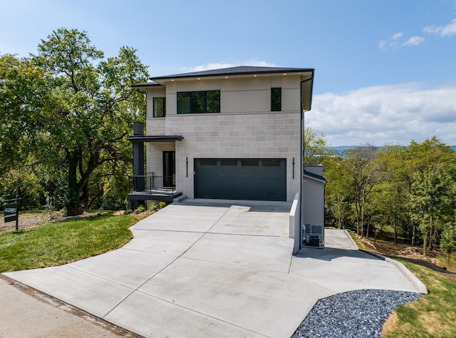 contemporary home with a garage and a front yard