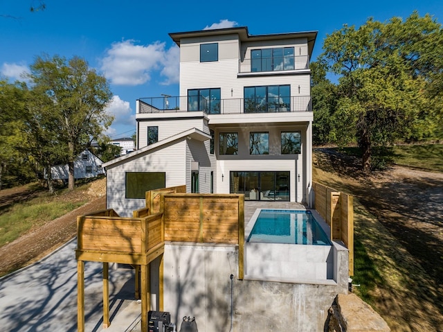 rear view of property featuring a balcony