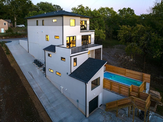 exterior space with a garage and a balcony