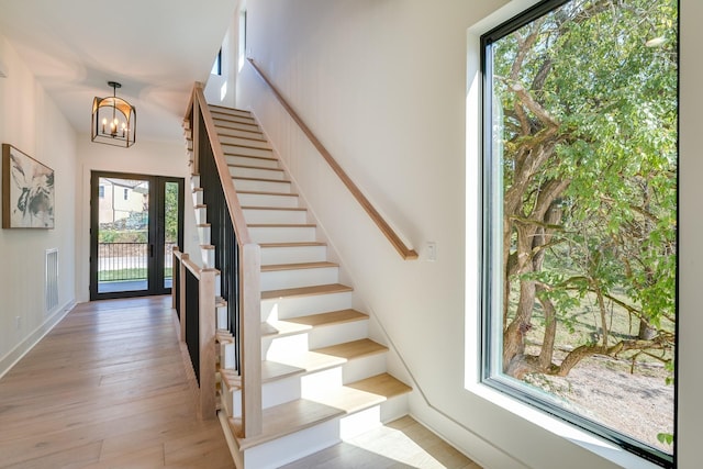 entryway with hardwood / wood-style flooring and an inviting chandelier