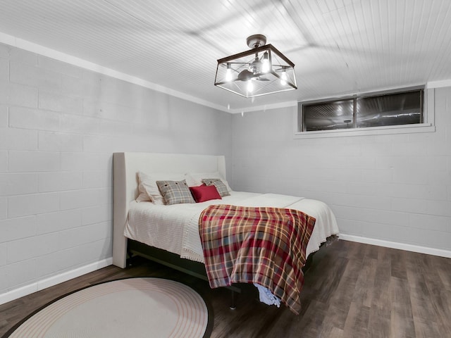 bedroom with dark hardwood / wood-style flooring