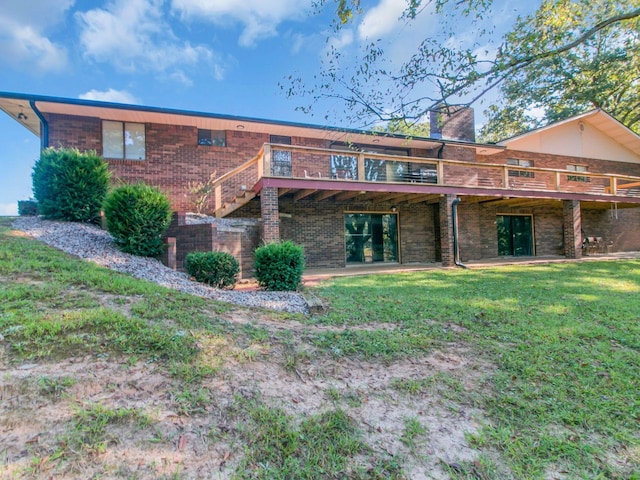 back of house with a yard and a deck