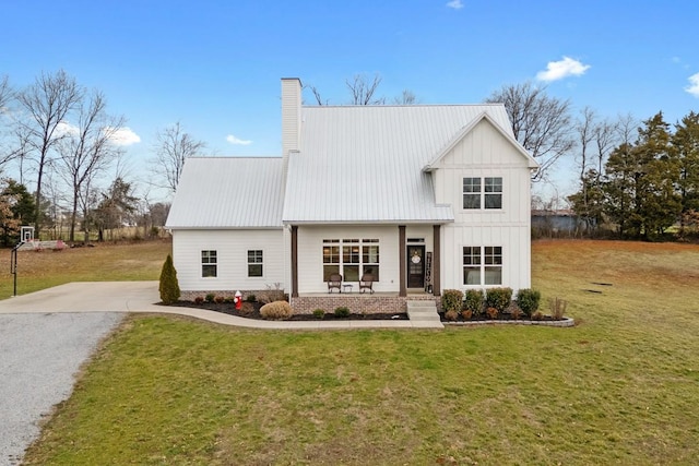 rear view of property with a yard