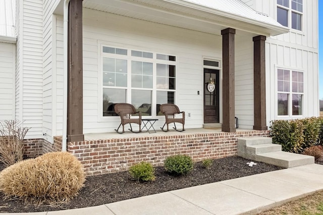 view of exterior entry with covered porch