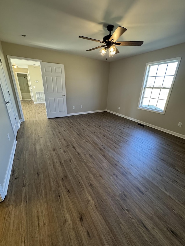 spare room with ceiling fan and dark hardwood / wood-style flooring