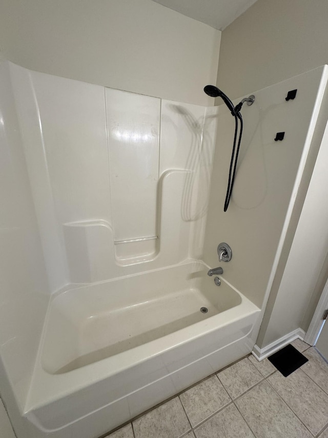 bathroom with tile patterned flooring and shower / tub combination