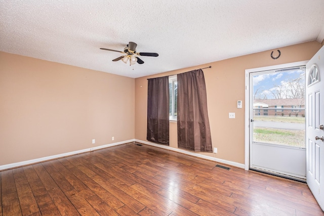 unfurnished room featuring ceiling fan, hardwood / wood-style flooring, and a textured ceiling