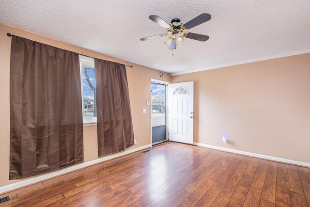 spare room with hardwood / wood-style flooring, ceiling fan, and a textured ceiling