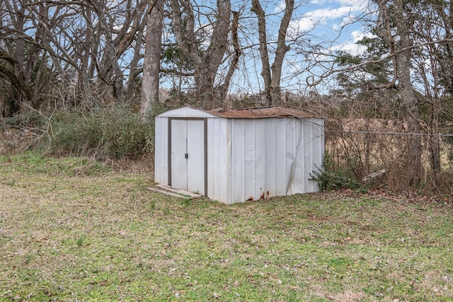 view of outbuilding with a yard