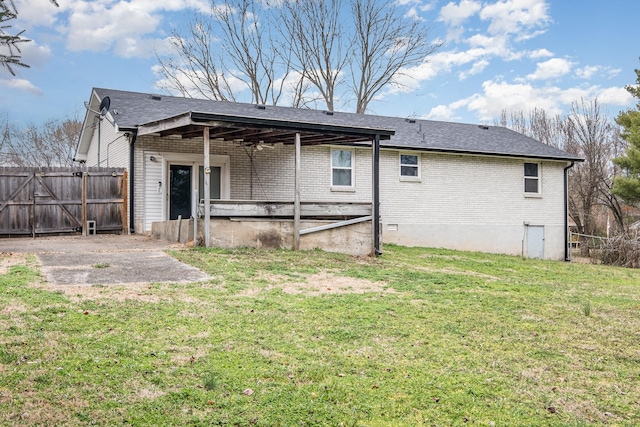 back of house with a yard and a patio