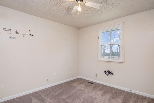 empty room featuring ceiling fan, carpet floors, and a textured ceiling