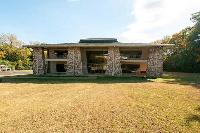 back of property featuring a lawn