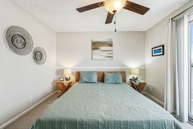 carpeted bedroom featuring ceiling fan and a textured ceiling