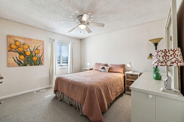 bedroom featuring ceiling fan, light carpet, and a textured ceiling