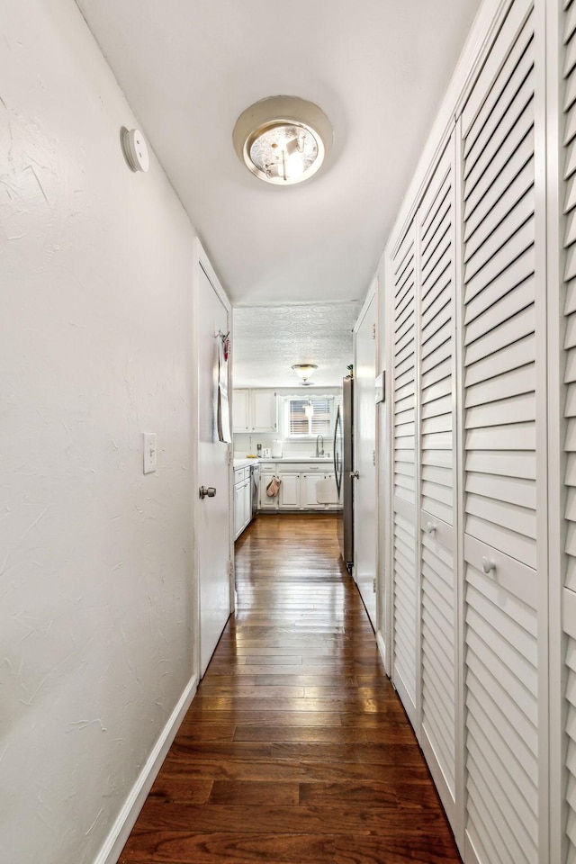 corridor featuring dark wood-type flooring