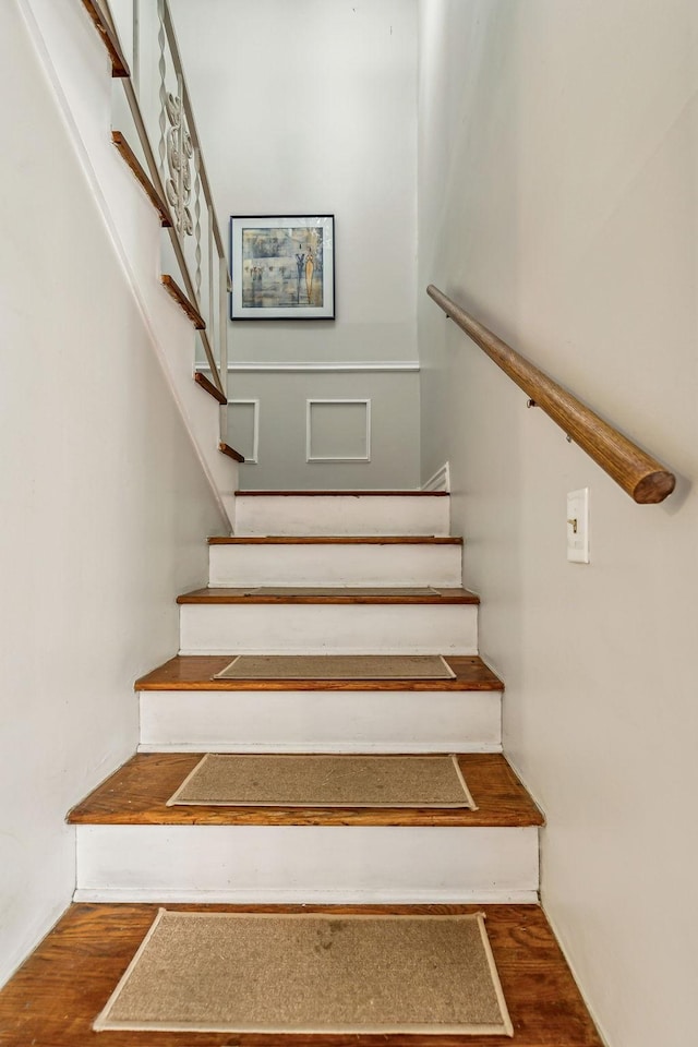 stairway with hardwood / wood-style flooring