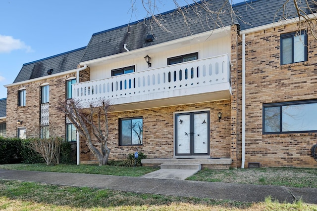 view of front of home featuring french doors and a balcony