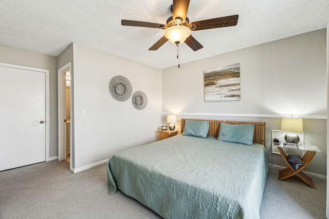 bedroom with ceiling fan, carpet floors, and a textured ceiling