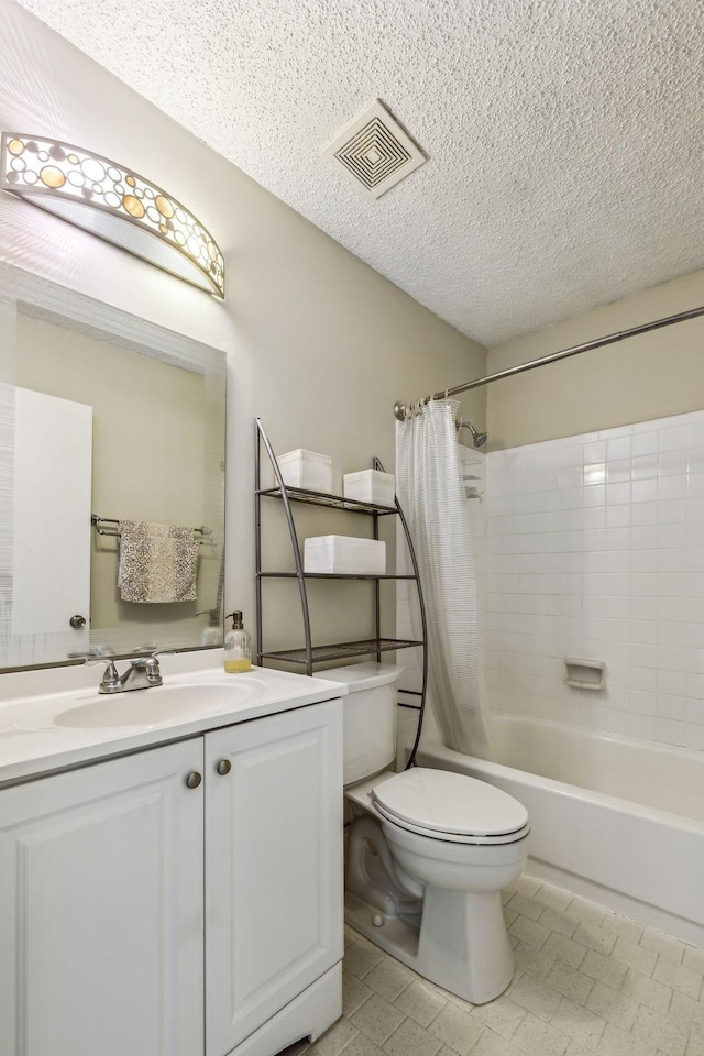 full bathroom featuring shower / bath combination with curtain, vanity, toilet, and a textured ceiling