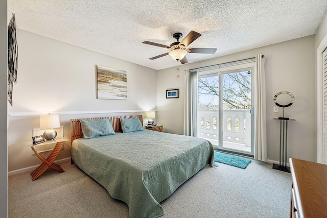 bedroom featuring ceiling fan, access to exterior, carpet floors, and a textured ceiling