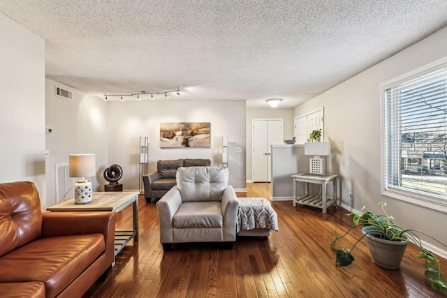 living room with hardwood / wood-style floors and a textured ceiling