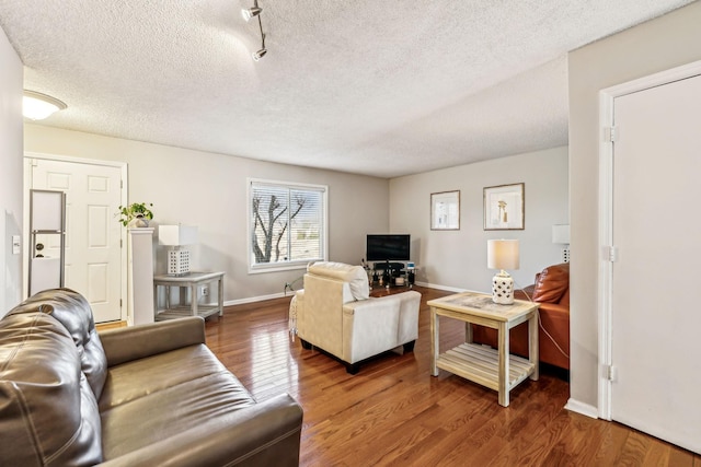 living room with wood-type flooring and a textured ceiling